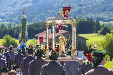 Ceremonial procession through streets and over fields