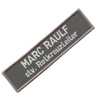textile name tag with two text lines and stitched border